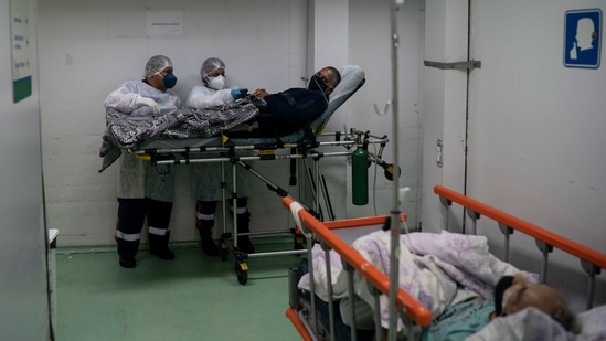Mobile Emergency Care Service (SAMU) workers prepare to move a Covid-19 patient to a municipal hospital in Duque de Caxias, Rio de Janeiro state on April 6. Brazil's health ministry on April 6 said 4,195 deaths were counted in the previous 24 hours, with the nation's pandemic toll quickly approaching 340,000, the second-highest in the world, AP reported.(AP/PTI)