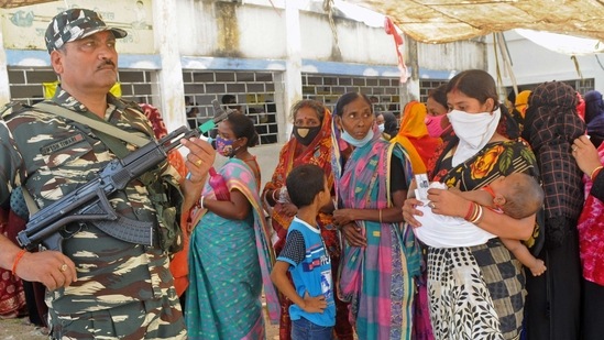 CRPF personnel stand guard as voter stand in a queue to cast their vote during third phase of West Bengal assembly elections, in Hooghly on April 6, 2021. (ANI Photo) CRPF personnel stand guard as voter stand in a queue to cast their vote during third phase of West Bengal assembly elections, in Hooghly on April 6, 2021. (ANI Photo)