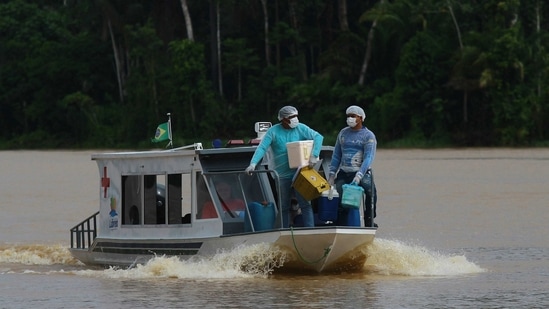 Healthcare workers travelling on a boat to the Santa Rosa community to vaccinate residents in Amazonas state on February 12. Only the US and Peru have had daily death tolls higher than 4,000.(Edmar Barros / AP)