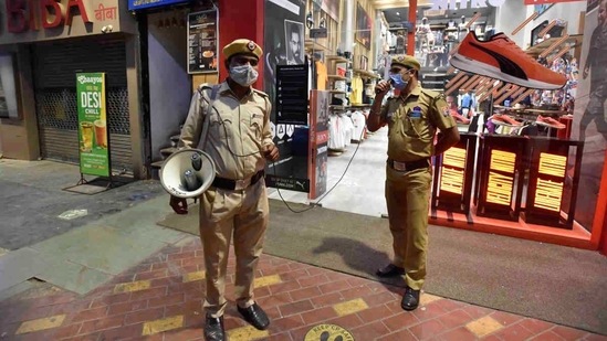 Civil Defence volunteers patrolling Connaught Place and making announcements of a night curfew coming into effect in New Delhi on April 6. Night curfews are among the most common non-pharmaceutical interventions used by governments to check the pandemic in Punjab, Rajasthan, Gujarat and Maharashtra.(Sanjeev Verma / HT Photo)