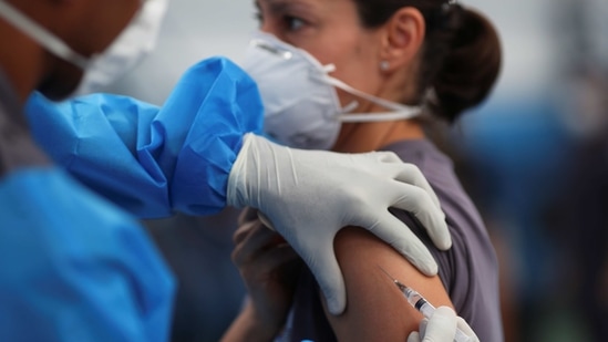 A police officer receives a dose of Covid-19 vaccine on the first day of state government vaccination for police officers, at Barro Branco Military Police Academy in Sao Paulo on April 5.(Amanda Perobelli / REUTERS)