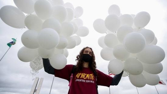 A nurse holds balloons during a protest demanding Covid-19 vaccines and in favour of SUS (Unique Health System) during World Health Day in Brasilia on April 7. According to Our World in Data, an online research site, less than 3% of Brazil's 210 million people have received both doses of coronavirus vaccines.(Adriano Machado / REUTERS)