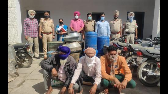 The three accused from Fatehwal village in Ajnala sub division of Amritsar district in police custody on Wednesday. They were manufacturing illicit liquor in their houses. (HT Photo)