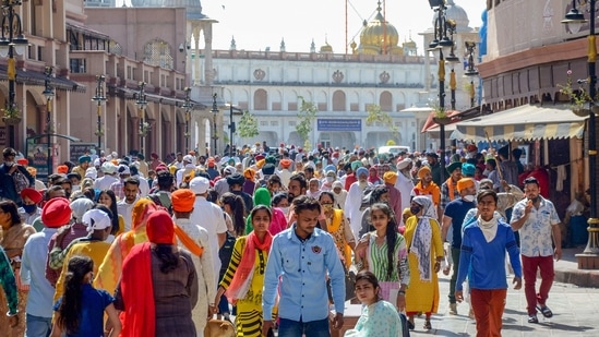 People, not adhering to Covid-19 norms, walking at the Heritage Street near Golden Temple, Amritsar. (PTI) People, not adhering to Covid-19 norms, walking at the Heritage Street near Golden Temple, Amritsar. (PTI)
