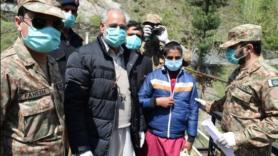 Before being handed over to Pakistan, the young man was given clothes and sweets. The exchange took place at 11:50 am on Wednesday. (HT PHOTO.) Before being handed over to Pakistan, the young man was given clothes and sweets. The exchange took place at 11:50 am on Wednesday. (HT PHOTO.)