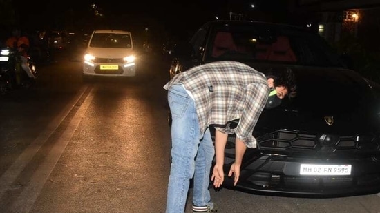 Kartik Aaryan touches lower portion of his new car's front.(Varinder Chawla)