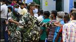 Paramilitary soldiers manage a queue at a polling booth during the third phase of West Bengal elections in Baruipur, South 24 Pargana district. (AP PHOTO.)