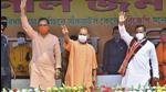 Uttar Pradesh chief minister Yogi Adityanath waves at the crowd during an election rally for the West Bengal assembly polls, at Sankrail in Howrah on Thursday. (PTI PHOTO.)