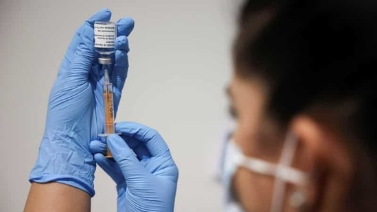A health worker prepares an injection with a dose of Astra Zeneca coronavirus vaccine, at a vaccination centre in Westfield Stratford City shopping centre. (Reuters File Photo )