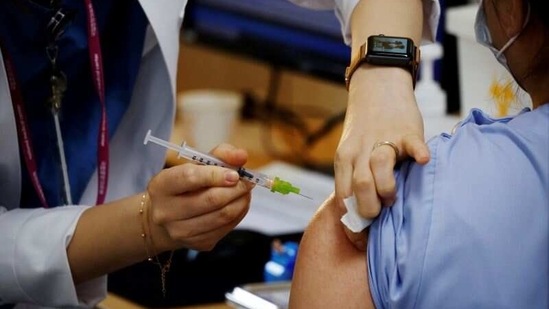 A health worker gets a dose of the Pfizer-BioNTech coronavirus disease (COVID-19) vaccine at a Covid-19 vaccination center.(REUTERS)