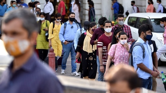 Commuters stand in a long queue outside a metro station at Connaught Place while entering in small groups as a preventive measure against the Covid-19, in New Delhi on Thursday. (ANI Photo)