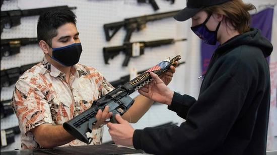 In this file photo, a customer looks at a custom made AR-15 style rifle at Davidson Defense in Orem, Utah. (AFP) In this file photo, a customer looks at a custom made AR-15 style rifle at Davidson Defense in Orem, Utah. (AFP)