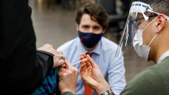 Canada's Prime Minister Justin Trudeau watches as a nurse gives a Covid-19 vaccination at a clinic in Ottawa. (REUTERS) Canada's Prime Minister Justin Trudeau watches as a nurse gives a Covid-19 vaccination at a clinic in Ottawa. (REUTERS)