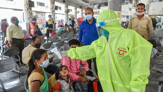 Lucknow: A health worker checks temperature of passengers as part of precautions against Covid-19, at bus station.(PTI file photo)