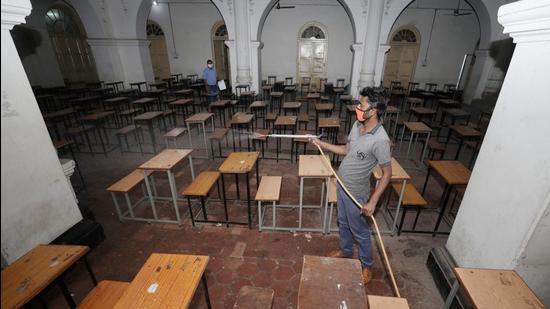 A health worker sanitises Government Gandhi Memorial Science College after students and staff members tested positive in Jammu on Thursday. (PTI) A health worker sanitises Government Gandhi Memorial Science College after students and staff members tested positive in Jammu on Thursday. (PTI)