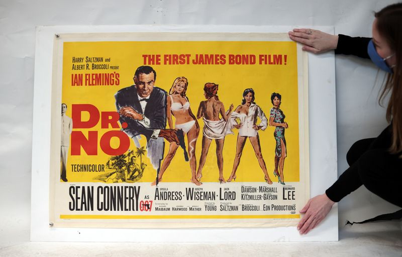 An auctioneer specialist checks a James Bond 'Dr No' (1962) British Quad film poster. (REUTERS)