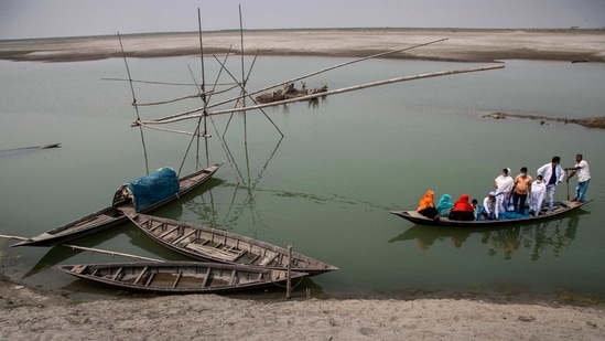 Health workers accompanying elderly villagers in a boat as they cross the river Brahmaputra to reach a Covid-19 vaccination center at Bahakajari village in Assam on March 23. Workers recently trekked to this tiny village to start vaccinating its nearly 9,000 residents. The vaccines were first sent to the nearest town, Morigaon, before they were driven the final leg by car. (Anupam Nath / AP) Health workers accompanying elderly villagers in a boat as they cross the river Brahmaputra to reach a Covid-19 vaccination center at Bahakajari village in Assam on March 23. Workers recently trekked to this tiny village to start vaccinating its nearly 9,000 residents. The vaccines were first sent to the nearest town, Morigaon, before they were driven the final leg by car. (Anupam Nath / AP)