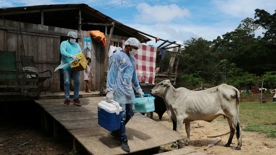 Health workers Diego Feitosa Ferreira, 28, (R), and Clemilton Lopes de Oliveira, 41, leave a home after a resident denied to be vaccinated against the new coronavirus, in the Capacini community, along the Purus river in Amazonas state, Brazil on February 12. Like many remote locales, getting the vaccine to the villages was important because most jungle communities have only basic medical facilities that aren't equipped to treat severe Covid-19 cases. (Edmar Barros/AP) Health workers Diego Feitosa Ferreira, 28, (R), and Clemilton Lopes de Oliveira, 41, leave a home after a resident denied to be vaccinated against the new coronavirus, in the Capacini community, along the Purus river in Amazonas state, Brazil on February 12. Like many remote locales, getting the vaccine to the villages was important because most jungle communities have only basic medical facilities that aren't equipped to treat severe Covid-19 cases. (Edmar Barros/AP)