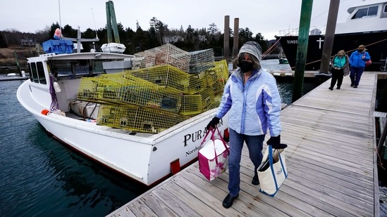 Nurse Sharon Daley carries a cooler of Covid-19 vaccinations as she and her staff begin a journey to inoculate island residents on March 19 in Northeast Harbor, Maine. In Maine, there was relief when the century-old Seacoast Mission took on the task of getting the vaccine to the islands. (Robert F. Bukaty/AP) Nurse Sharon Daley carries a cooler of Covid-19 vaccinations as she and her staff begin a journey to inoculate island residents on March 19 in Northeast Harbor, Maine. In Maine, there was relief when the century-old Seacoast Mission took on the task of getting the vaccine to the islands. (Robert F. Bukaty/AP)
