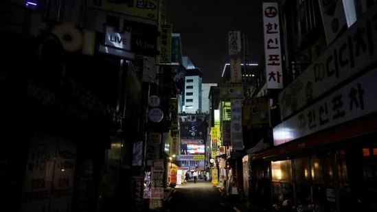 People walk past closed pubs and restaurants as tougher social distancing rules to prevent the coronavirus disease (Covid-19) that have been announced on the last Friday continue, in Seoul, South Korea. (Reuters)