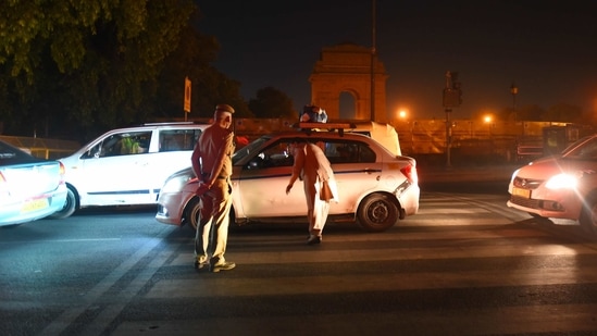 Police personnel checking commuters for documents and passes near India Gate during a night curfew in the city amid a rise in Covid-19 cases, in New Delhi (Raj K Raj/HT Photo) Police personnel checking commuters for documents and passes near India Gate during a night curfew in the city amid a rise in Covid-19 cases, in New Delhi (Raj K Raj/HT Photo)