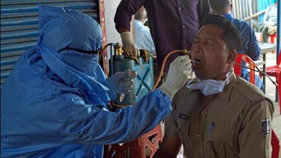 File photo: A health worker collects swab sample of a police personnel in Bhubaneswar, Odisha (ANI)