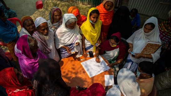 Elderly women wait to register for a Covid-19 vaccine in Bahakajari village in Assam on March 23. People from a nearby island were brought to the health center by boat, and both men and women lined up to get vaccinated. By the end of the day, 67 had received a shot, with officials aiming to vaccinate 800 more within the next three days. (Anupam Nath/AP) Elderly women wait to register for a Covid-19 vaccine in Bahakajari village in Assam on March 23. People from a nearby island were brought to the health center by boat, and both men and women lined up to get vaccinated. By the end of the day, 67 had received a shot, with officials aiming to vaccinate 800 more within the next three days. (Anupam Nath/AP)