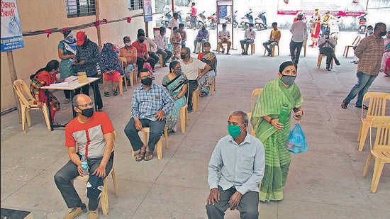 People wait outside a Covid vaccination centre in Pune , on Friday. (RAVINDRA JOSHI/HT) People wait outside a Covid vaccination centre in Pune , on Friday. (RAVINDRA JOSHI/HT)
