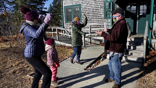 Island residents, Lindsay Eysnogle, (L), her daughter, Marina Pickering and Kaitlyn Miller, (C), dance with Mitchell McCormick to celebrate their Covid-19 vaccinations on March 19 on Islesford, Maine. Islanders are used to a certain degree of isolation, but this winter was particularly tough due to restrictions, Lindsay Eysnogle, who teaches five children on the island ranging from pre-K to second grade, told AP. The vaccine provides hope that islanders can resume something akin to normalcy. (Robert F. Bukaty/AP) Island residents, Lindsay Eysnogle, (L), her daughter, Marina Pickering and Kaitlyn Miller, (C), dance with Mitchell McCormick to celebrate their Covid-19 vaccinations on March 19 on Islesford, Maine. Islanders are used to a certain degree of isolation, but this winter was particularly tough due to restrictions, Lindsay Eysnogle, who teaches five children on the island ranging from pre-K to second grade, told AP. The vaccine provides hope that islanders can resume something akin to normalcy. (Robert F. Bukaty/AP)