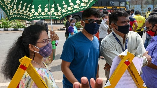 People stand behind outside a Covid-19 vaccination centre as inoculation stopped due to shortage of supplies in Mumbai. (AFP) People stand behind outside a Covid-19 vaccination centre as inoculation stopped due to shortage of supplies in Mumbai. (AFP)