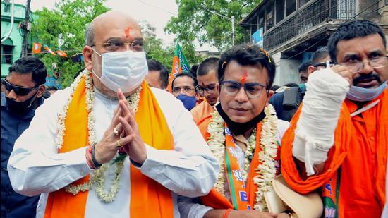 Union Home Minister and BJP leader Amit Shah during his door-to-door election campaign in favour of party candidate from Bhawanipore assembly constituency Rudranil Ghosh, in Kolkata on Friday. (PTI PHOTO.) Union Home Minister and BJP leader Amit Shah during his door-to-door election campaign in favour of party candidate from Bhawanipore assembly constituency Rudranil Ghosh, in Kolkata on Friday. (PTI PHOTO.)
