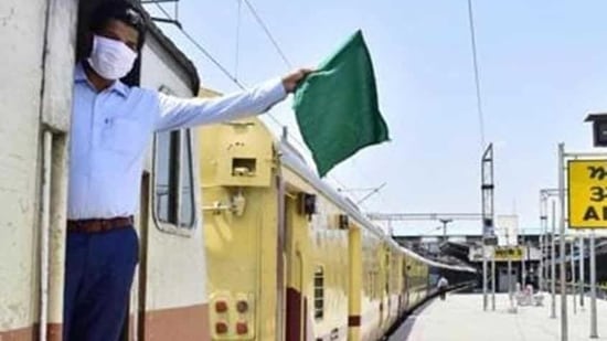 An Indian Railways guard waves the green flag (HT Poto/Sameer Sehgal) An Indian Railways guard waves the green flag (HT Poto/Sameer Sehgal)
