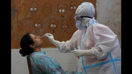A health worker collecting the swab sample of a staff member at Government College of Art, Sector 10, in Chandigarh on Friday. (Ravi Kumar/HT) A health worker collecting the swab sample of a staff member at Government College of Art, Sector 10, in Chandigarh on Friday. (Ravi Kumar/HT)