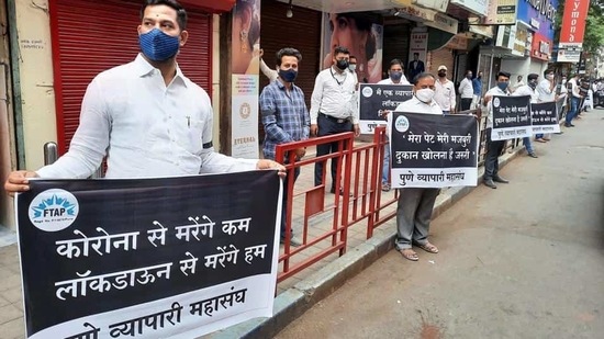 Traders during a protest against Maharashtra government's decision to close all shops except those providing essential services in view of the surge in Covid-19 cases, in Pune, Thursday. (PTI)