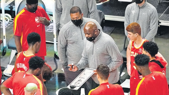 Atlanta Hawks head coach Nate McMillan, center, draws a play before the start of the second half of an NBA basketball game after the game Wednesday, April 7, 2021, in Atlanta. (AP)
