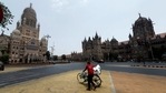 A man walks with his bicycle in front of the Brihanmumbai Municipal Corporation (BMC) building and the Chhatrapati Shivaji Maharaj Terminus (CSMT) during a weekend lockdown on April 10 in Mumbai. A weekend lockdown in light of rising Covid-19 cases came into effect across Maharashtra from 8pm on April 9 and will be in place till 7am on April 12. A man walks with his bicycle in front of the Brihanmumbai Municipal Corporation (BMC) building and the Chhatrapati Shivaji Maharaj Terminus (CSMT) during a weekend lockdown on April 10 in Mumbai. A weekend lockdown in light of rising Covid-19 cases came into effect across Maharashtra from 8pm on April 9 and will be in place till 7am on April 12.