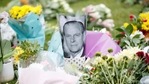 A picture of late Prince Philip is placed among flowers outside Windsor Castle.(Reuters)