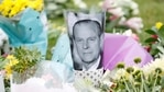 A picture of Britain's Prince Philip is placed among flowers outside Windsor Castle, following his death at the age of 99, in Windsor, near London on April 10, 2021(Reuters Photo)