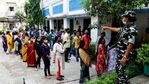 A paramilitary soldier stands guard as voters wait outside at a polling station during the fourth phase of West Bengal state elections.(AP)