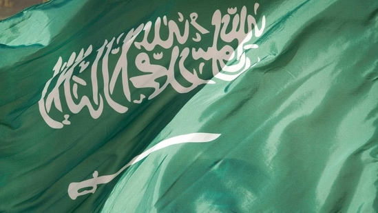 FILE - In this March 22, 2018, file photo, an honor guard member is covered by the flag of Saudi Arabia, in Washington. Three young Saudi men who faced death sentences for acts they were accused of committing as minors have been handed a 10-year prison sentence instead, the Saudi Human Rights Commission said. The move comes nearly a year after Saudi Arabia ordered an end to the death penalty for crimes committed by minors. Crown Prince Mohammed bin Salman, is the force behind the kingdom’s efforts to modernize the country and loosen restrictions. (AP Photo/Cliff Owen, File) (AP) FILE - In this March 22, 2018, file photo, an honor guard member is covered by the flag of Saudi Arabia, in Washington. Three young Saudi men who faced death sentences for acts they were accused of committing as minors have been handed a 10-year prison sentence instead, the Saudi Human Rights Commission said. The move comes nearly a year after Saudi Arabia ordered an end to the death penalty for crimes committed by minors. Crown Prince Mohammed bin Salman, is the force behind the kingdom’s efforts to modernize the country and loosen restrictions. (AP Photo/Cliff Owen, File) (AP)
