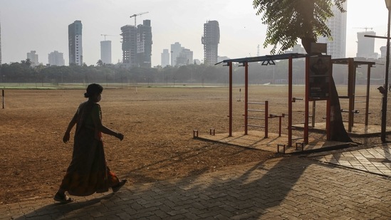 A woman walking through the Dadar Shivaji Park during the weekend lockdown in Mumbai on April 10. State health minister Rajesh Tope had on April 9 said that the state is heading towards complete lockdown and is hoping to bring the situation under control before that.(Dhiraj Singh/Bloomberg)