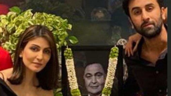 Ranbir Kapoor and Riddhima Kapoor Sahni pose with Rishi Kapoor's photo. 