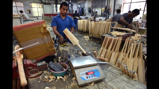 An artisan at the SG factory levels the edges of a bat after it has been shaped from a cleft. This bat will have a cylindrical handle. Some players prefer handles that are long, oval or tapered. Whatever the shape, top-of-the-line handles are all made using Sarawak cane imported from Malaysia. (HT Archive) An artisan at the SG factory levels the edges of a bat after it has been shaped from a cleft. This bat will have a cylindrical handle. Some players prefer handles that are long, oval or tapered. Whatever the shape, top-of-the-line handles are all made using Sarawak cane imported from Malaysia. (HT Archive)
