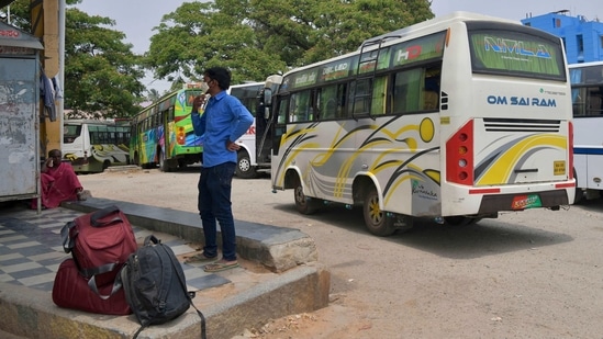 Passengers wait to board private buses at the Nelamangala Rural Bust Stand in Bangalore during an indefinite strike by Karnataka State Road Transport Corporation (KSRTC) workers demanding wage revisions. (AFP) Passengers wait to board private buses at the Nelamangala Rural Bust Stand in Bangalore during an indefinite strike by Karnataka State Road Transport Corporation (KSRTC) workers demanding wage revisions. (AFP)