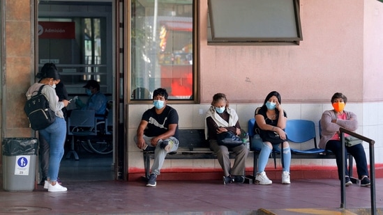 People wait to be assisted outside the San Jose Hospital as the healthcare system is saturated due to the high number of Covid-19 infections, in Santiago. People wait to be assisted outside the San Jose Hospital as the healthcare system is saturated due to the high number of Covid-19 infections, in Santiago.