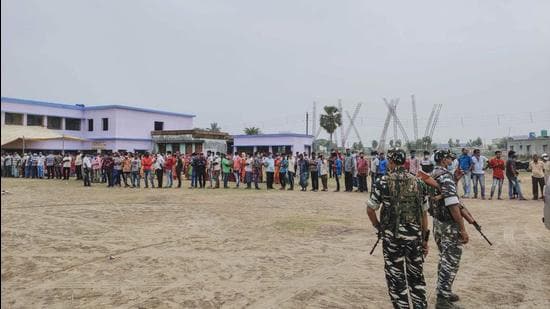 Security personnel stand a guard at a polling station during the fourth phase of West Bengal Assembly elections on Saturday. (PTI)