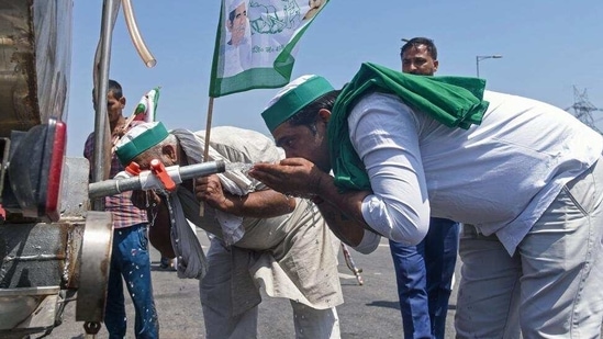 Farmers quench their thirst during blocking Kundli-Manesar-Palwal expressway for 24 hrs as they protest against new farm laws on April 10, 2021. (ANI Photo) Farmers quench their thirst during blocking Kundli-Manesar-Palwal expressway for 24 hrs as they protest against new farm laws on April 10, 2021. (ANI Photo)