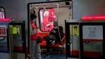 Commuters wearing face masks browse their smartphones inside a subway train in Beijing.(AP) Commuters wearing face masks browse their smartphones inside a subway train in Beijing.(AP)