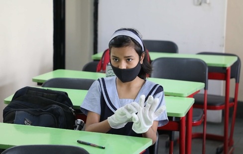 A student sanitizes her hands at City Montessori school in Lucknow, Uttar Pradesh in this file photo from March 2021. Schools for classes 1 to 12 will remain closed in UP due to current Covid-19 situation. (Deepak Gupta / Hindustan Times)