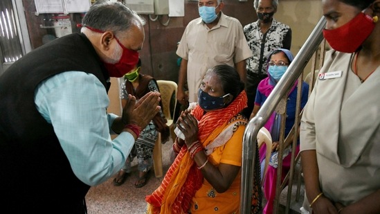 North Delhi Mayor Jai Prakash greets people at the inoculation centre as the 'Tika Utsav' begins at a local health center in New Delhi on Sunday. (ANI Photo) North Delhi Mayor Jai Prakash greets people at the inoculation centre as the 'Tika Utsav' begins at a local health center in New Delhi on Sunday. (ANI Photo)
